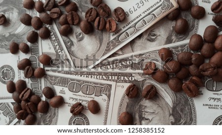 roll of american dollars and coffee beans background