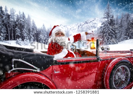 Santa Claus in red car and snowflakes decoration 