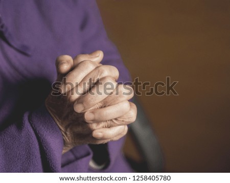 Close-up of old woman hands of praying. Space for text.