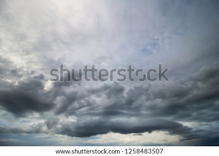 Soft focus of storm clouds and colorful dramatic sky reflection water on lake before storm in evening at Huai Luang Dam Udonthani,thailand. Nature smooth skyscape photography background.
