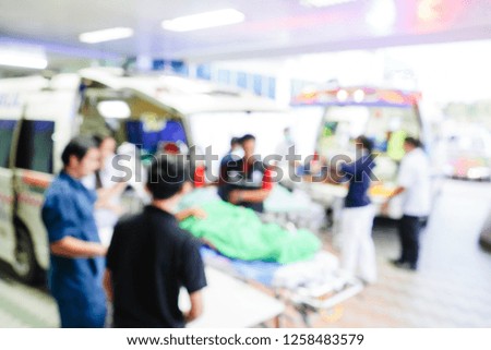 Blurred picture of nurse take care of the patient in ambulance. The patient have had accident and suffer from head injury.