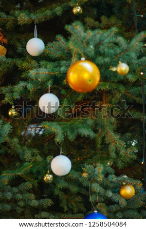 Holiday. Decorated Christmas tree on blurred, sparkling and fairy background. Selective focus. Some christmas detail is blur.