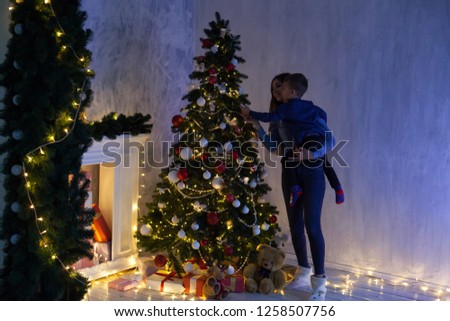 a boy with a gift for new year Christmas tree winter holiday