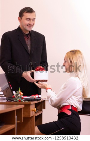 Young business man and woman working in an office at holidays