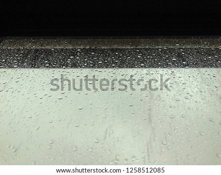 The raindrop on the window glass
