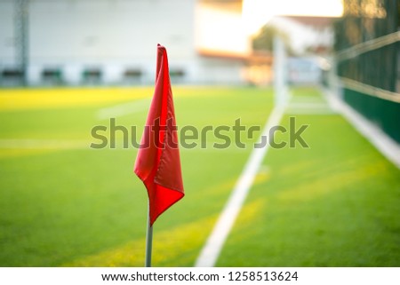 Red flag corner of football soccer field on light sun is beauty