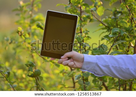 Tablet computer in  children's hand on nature