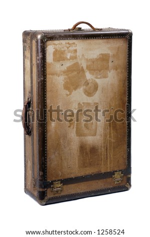 A battered old suitcase shows the traces of luggage labels from world travel, standing upright Royalty-Free Stock Photo #1258524