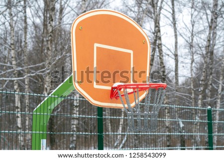 Outdoor sports basketball basket covered with snow