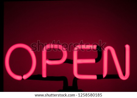 A neon "open" sign glowing red Bar open light neon sign night store red pink glowing  background