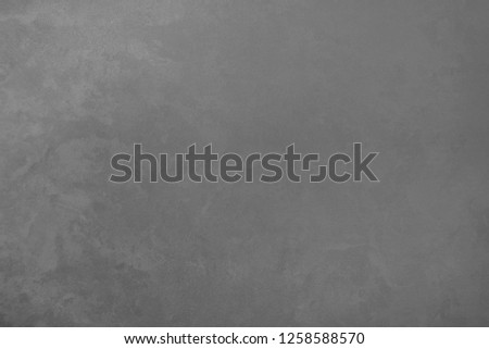 Gray classic texture for the designer background. Illuminated surface. Space to fill. Artistic plaster. Illuminated, rough wall. Abstract pattern. Raster image.