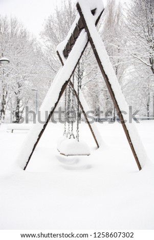 Snowy swings in park