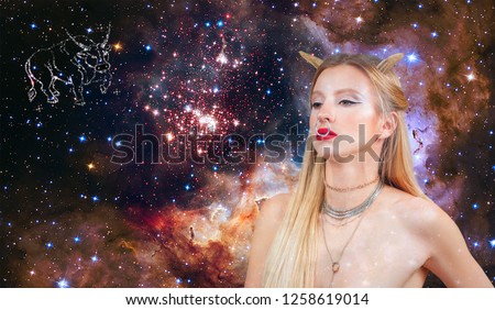 Taurus Zodiac Sign. Astrology and horoscope concept. Beautiful woman Taurus on the galaxy background