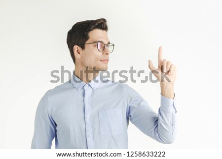 Young hipster office man confident and staid pointing finger up, portrait shot isolated on white background.