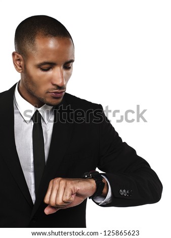 Young businessman checking the time against white background