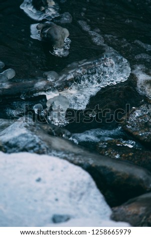 Ice and rocks on the beach. Frozen background