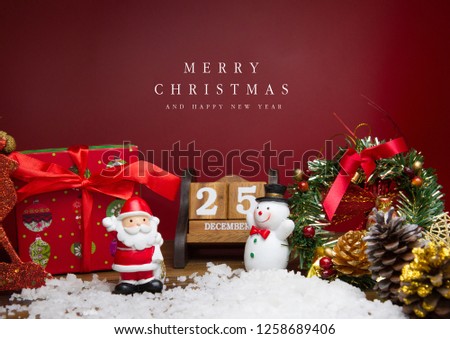 Santa Claus and Snow man Doll  with Wooden calendar set on the 25 of december  on red background, christmas concept
