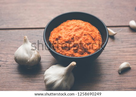 Garlic chutney, made using lahsun/lehsun originating from the India, served in a bowl over moody background. selective focus