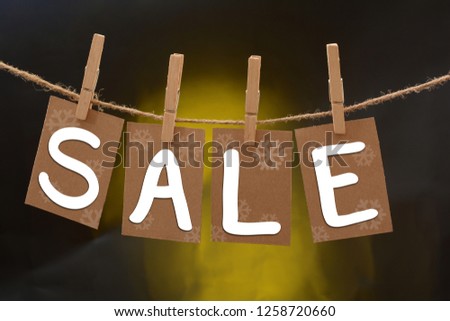 Season Sale reminder hanging with ropes on Gray background