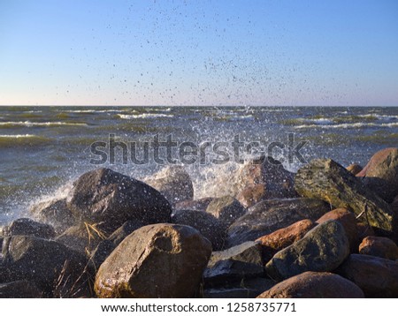 Waves splashing on rocky shore by Baltic Sea in Finland