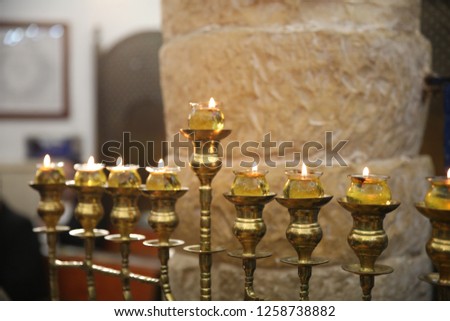 A fully lit "menorah" (candelabrum) used as a Jewish ritual on the holiday of Hanukkah using olive oil