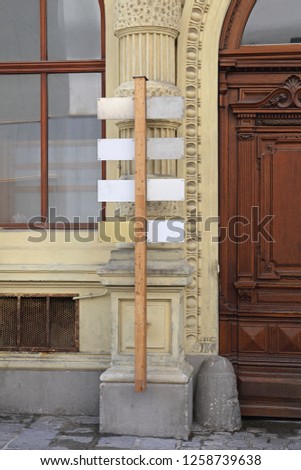 Wooden Sign Pole in Front of Building in Vienna