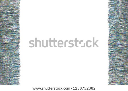 Frame made from silver and colorful tinsel, isolated on white background with clipping path and copy space in the middle. Decorations for christmas.