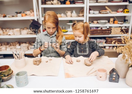 little girls spending time in the clay studio. close up photo.