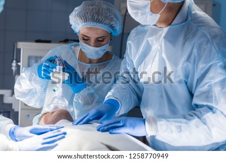 Team of experienced doctors and assistants performing difficult abdominal surgery, using the chance to save patient s life, and there is no greater calling in the world than that. Royalty-Free Stock Photo #1258770949