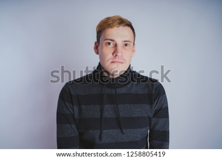 Emotional portrait of a guy, business style clothes: sweater and jeans.
. emotional portrait. short hair and clean skin. Young brutal man with short hair, emotional portrait.
