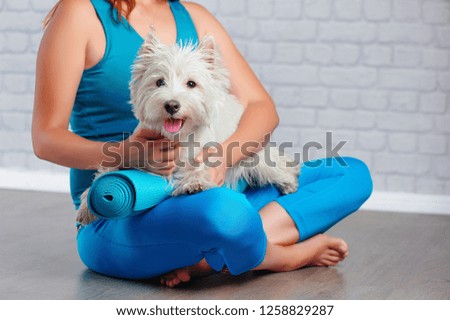 Closeup picture of a yoga girl hugging her doggie