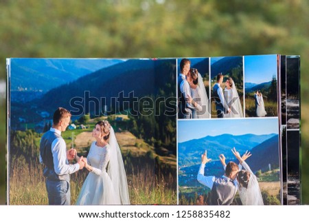 Pages of wedding photobook or wedding album on green background.