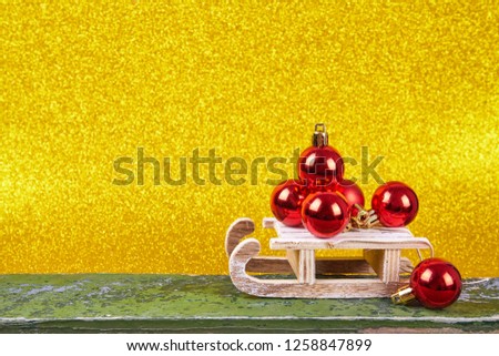 Christmas sled on gold background with copy space