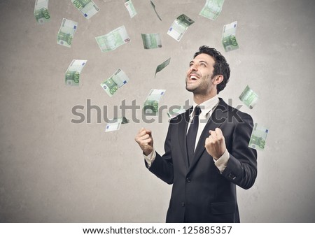 Businessman rejoicing for his success with hundred-euro banknotes flying in the air