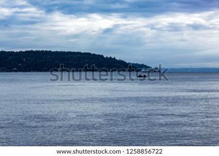 early morning ferry alongpuget sound with small speed boat