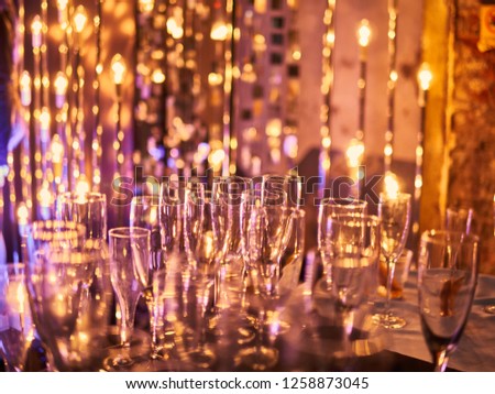 New years eve festive celebration blurry background with glasses of champagne. Vintage gold Fireworks and bokeh in New Year eve and copy space. holiday background
