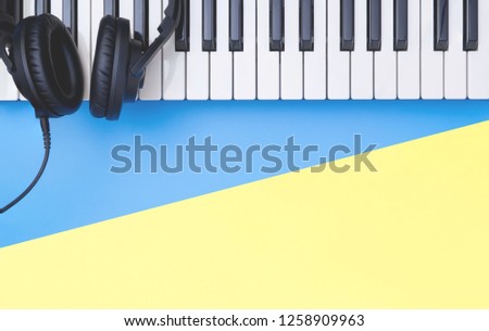 Music keyboard instrument with headphone on blue yellow copy space for Music concept