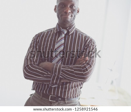 Portrait of an handsome black businessman standing in office