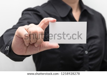Woman hand holding a business card