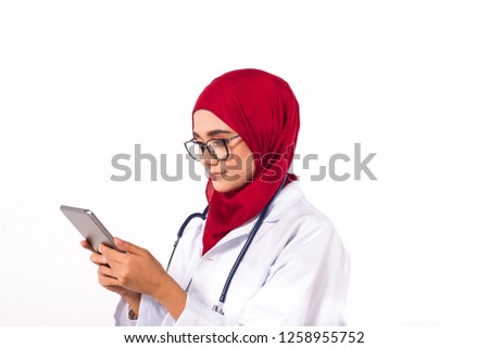 Muslim Female Doctor holding a tablet. White Background, Red Hijab
