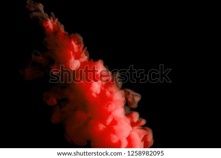 paint stream in water, red colored ink cloud on black background, abstract background