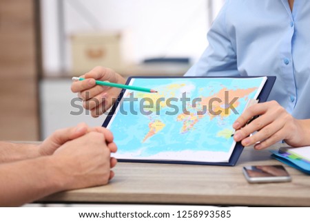 Female manager consulting client in travel agency, closeup