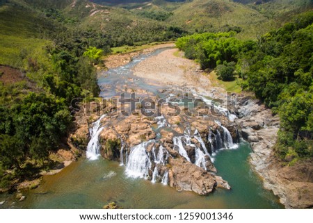 Impressive waterfalls on Koua river aerial view, between Poro and Kouaoua, North Province, New Caledonia, Melanesia, Oceania, overseas territory of France, South Pacific Ocean. Royalty-Free Stock Photo #1259001346