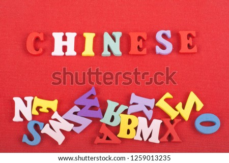 CHINESE word on red background composed from colorful abc alphabet block wooden letters, copy space for ad text. Learning english concept