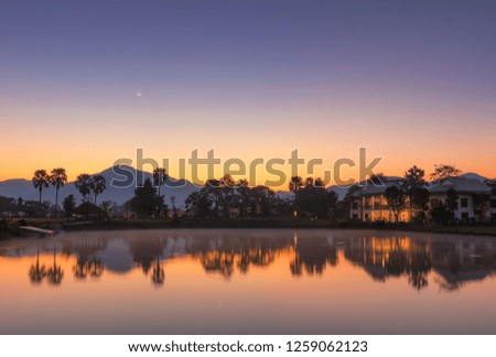 Landscape view of dutch farm, Chiang mai during sunrise with the Mountains in the background, Beautiful colors with reflection.
