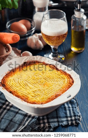Shepherd's pie or cottage pie. Minced beef meat and vegetables with mashed potatoes in casserole dish