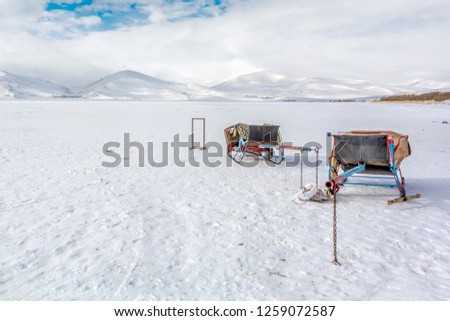 Full-fledged Hors cars on frozen Cildir Lake (Cildir goli) in Ardahan near Kars, Turkey