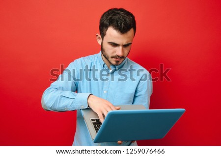 Portrait of young man working at his laptop