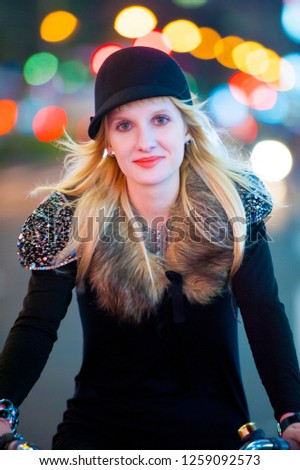 Caucasian female model poses for pictures on the street