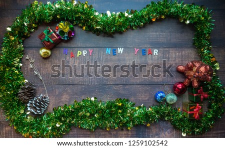 Happy New year background with fir tree and decor on wood background. Top view with copy space.